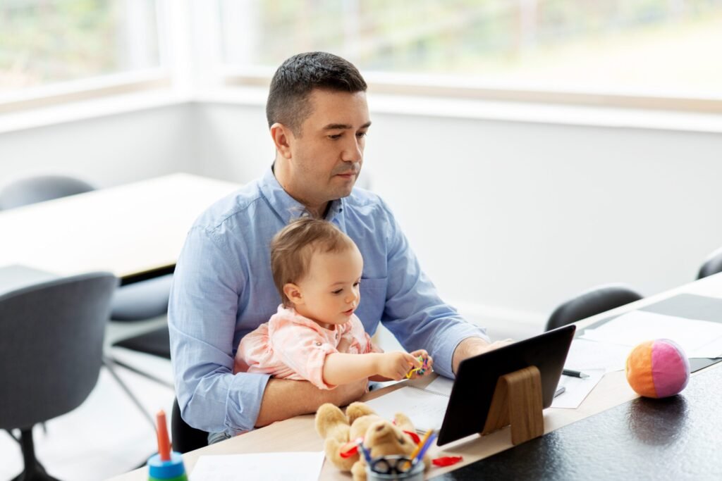 father with baby working on tablet pc at home - Thor Wealth Managment, Inc.