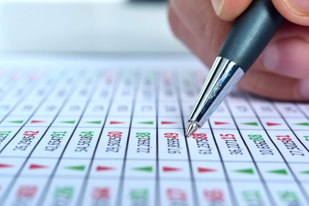 Businessman hand with pen correction stock market report with stock data. - Thor Wealth Managment, Inc. mean reversion investing